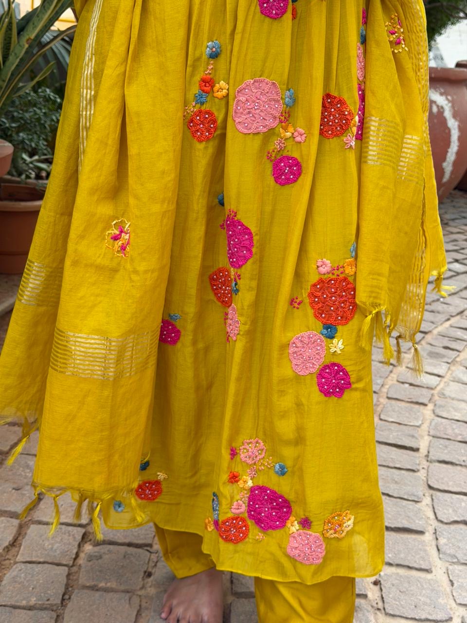 A0621 mustard mul chanderi 3 piece suit with applique, hand embroidery & pleats over the yoke part & butties all over the duppatta
