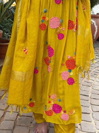 A0621 mustard mul chanderi 3 piece suit with applique, hand embroidery & pleats over the yoke part & butties all over the duppatta