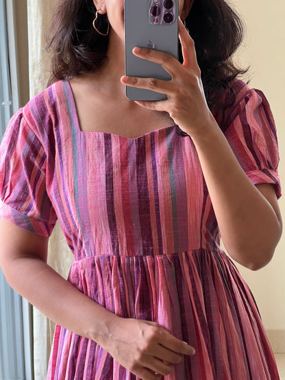 A0525 pink handloom cotton one piece dress in stripes and gathering at bottom of the dress