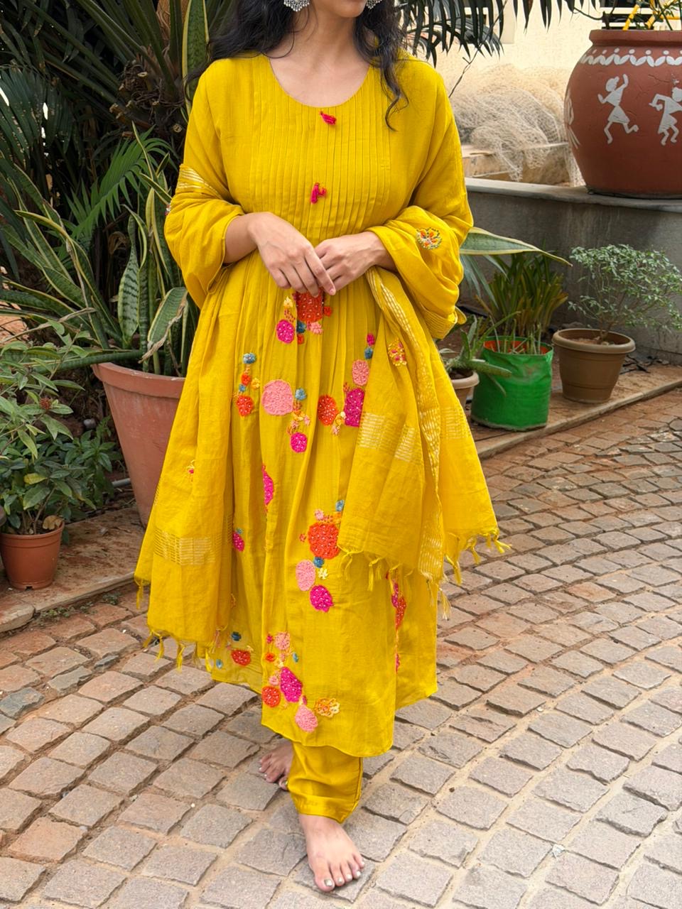 A0621 mustard mul chanderi 3 piece suit with applique, hand embroidery & pleats over the yoke part & butties all over the duppatta