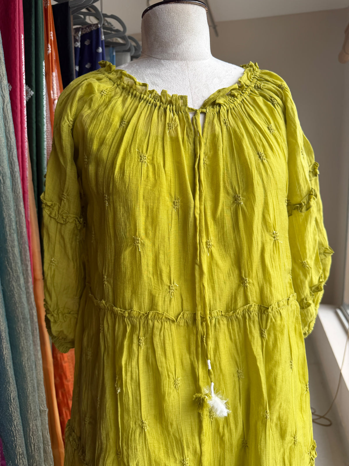 Green tier dress with embroidery butties all over the dress