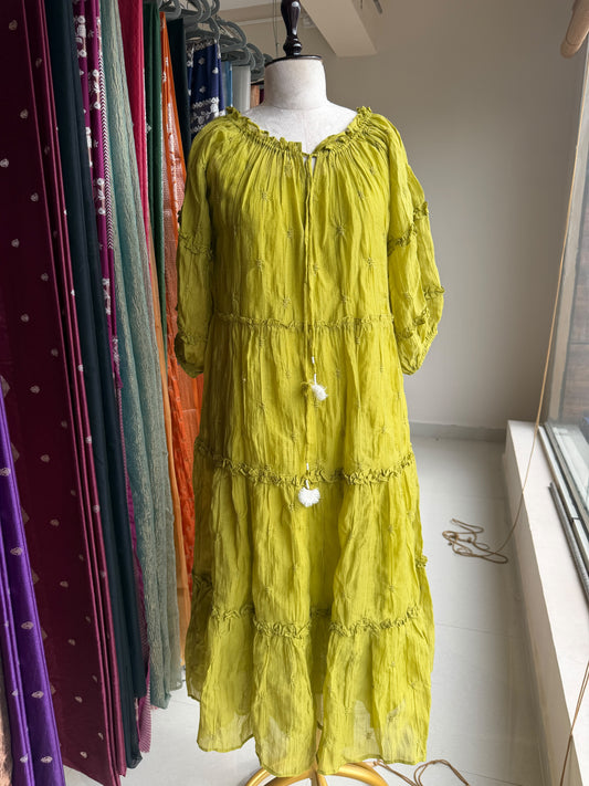Green tier dress with embroidery butties all over the dress