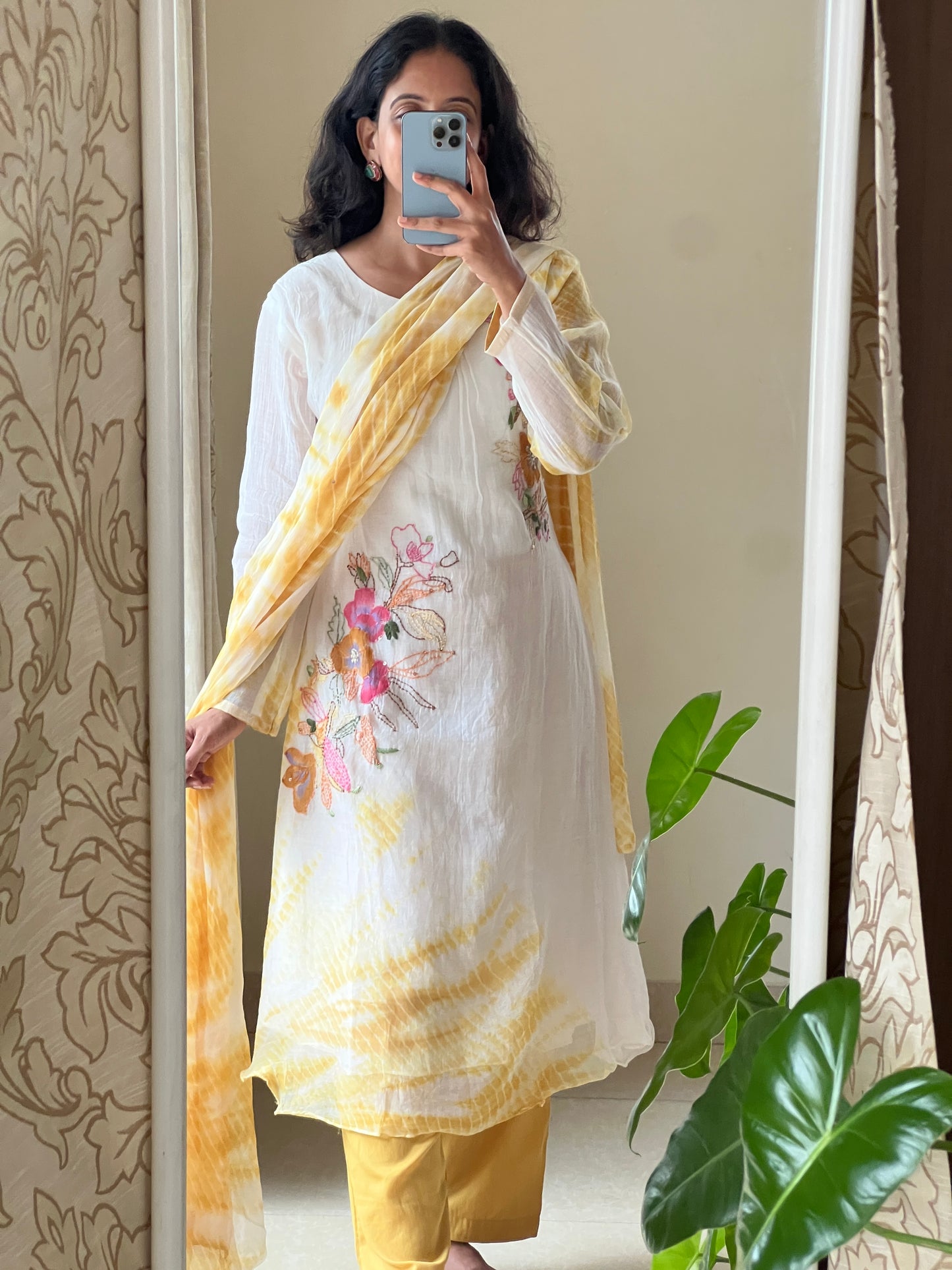 A0502 white & yellow tie dye mul chanderi 3 piece dress with hand paint & embroidery detailing comes with chiffon tie dye duppatta. The best part of this dress is at back part also you have same floral bunch detailing with hand paint & embroidery