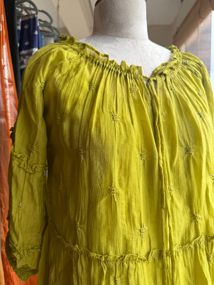 Green tier dress with embroidery butties all over the dress