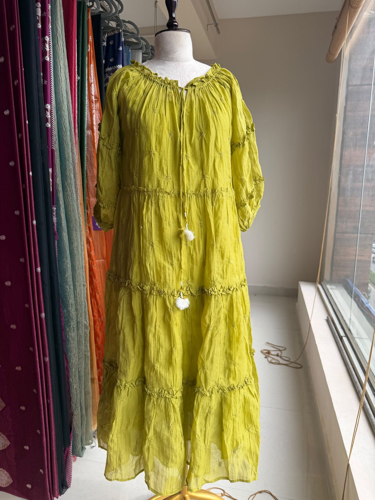 Green tier dress with embroidery butties all over the dress