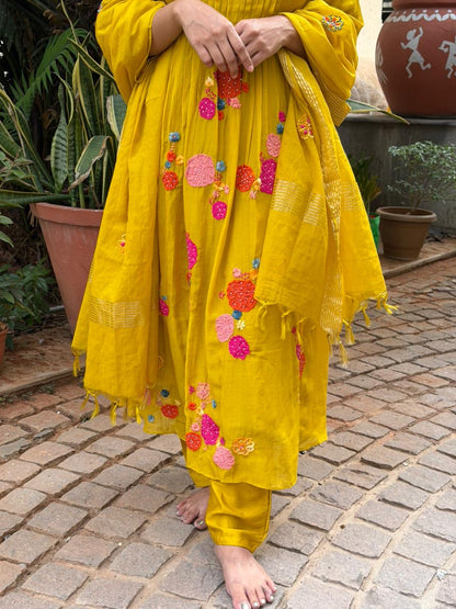 A0621 mustard mul chanderi 3 piece suit with applique, hand embroidery & pleats over the yoke part & butties all over the duppatta